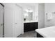 Well-lit bathroom featuring a dark wood vanity, dual sinks, modern fixtures, and a separate shower, creating a functional space at 3113 E Danbury Rd # 10, Phoenix, AZ 85032