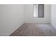 Empty room features neutral carpet, white walls, and natural light from a single window at 3113 E Danbury Rd # 10, Phoenix, AZ 85032
