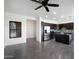 Modern kitchen featuring stainless steel appliances, dark cabinetry, and a center island, complemented by tile flooring and a ceiling fan at 3113 E Danbury Rd # 10, Phoenix, AZ 85032