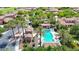 Aerial view showcasing the community pool, lush landscaping, and the surrounding neighborhood at 3467 N Hooper St, Buckeye, AZ 85396