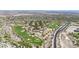 An aerial view showcasing a lush golf course community with homes dotting the landscape at 3467 N Hooper St, Buckeye, AZ 85396