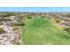 Aerial view of a lush green golf course with houses nearby at 3467 N Hooper St, Buckeye, AZ 85396