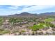 Scenic aerial view of houses surrounding a golf course with mountains at 3467 N Hooper St, Buckeye, AZ 85396