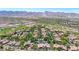 Stunning aerial shot of a Primary-planned community with a golf course and mountain views at 3467 N Hooper St, Buckeye, AZ 85396