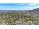 Expansive aerial view of a golf community nestled against mountains under a clear blue sky at 3467 N Hooper St, Buckeye, AZ 85396