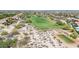 Aerial view of a golf course surrounded by homes at 3467 N Hooper St, Buckeye, AZ 85396