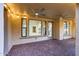 Covered back patio with brick flooring, ceiling fans and views into home's interior at 3467 N Hooper St, Buckeye, AZ 85396