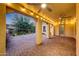 Spacious back patio features ceiling fans, exterior lighting, and stylish brick flooring at 3467 N Hooper St, Buckeye, AZ 85396