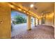 Spacious covered patio with brick pavers, ceiling fans, and elegant lighting for outdoor living at 3467 N Hooper St, Buckeye, AZ 85396
