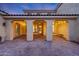 Spacious outdoor back patio features elegant stone flooring, lighting, and ceiling fans at 3467 N Hooper St, Buckeye, AZ 85396