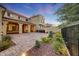 A beautifully landscaped backyard patio and garden features stone flooring and stylish desert landscaping at 3467 N Hooper St, Buckeye, AZ 85396