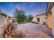 Beautifully landscaped backyard with brick pavers creating a serene outdoor retreat at 3467 N Hooper St, Buckeye, AZ 85396