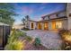 Large paver backyard with beautiful landscaping and uplighting, ideal for entertaining or relaxing outdoors at 3467 N Hooper St, Buckeye, AZ 85396