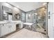 Luxurious bathroom with tub, separate glass shower with marble-look surround and modern vanity at 3467 N Hooper St, Buckeye, AZ 85396