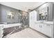 Bathroom features a soaking tub, glass-enclosed shower with marble-look surround, and dual sinks at 3467 N Hooper St, Buckeye, AZ 85396