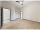 Neutral bedroom featuring wood-look tile floors, ceiling fan, two doors to walk-in closets, and white walls at 3467 N Hooper St, Buckeye, AZ 85396