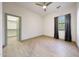 Bright bedroom features neutral walls, wood-look tile floors, ceiling fan, a window and a walk-in closet at 3467 N Hooper St, Buckeye, AZ 85396