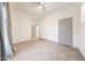 Neutral bedroom with tile floors, ceiling fan, and bright lighting at 3467 N Hooper St, Buckeye, AZ 85396