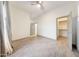 Bright bedroom featuring neutral walls, wood-look tile floors, ceiling fan, and a walk-in closet at 3467 N Hooper St, Buckeye, AZ 85396