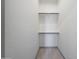 Bright, simple walk-in closet with wood-look flooring and basic shelving at 3467 N Hooper St, Buckeye, AZ 85396