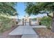 View of a community pool surrounded by mature landscaping and palm trees at 3467 N Hooper St, Buckeye, AZ 85396