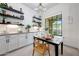 Bright dining area with floating shelves, modern lighting, and a large window at 3467 N Hooper St, Buckeye, AZ 85396