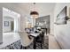 Elegant dining room featuring stylish decor, contemporary lighting, and large windows at 3467 N Hooper St, Buckeye, AZ 85396
