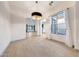 Dining room featuring tile floors, a chandelier, and natural light from a window at 3467 N Hooper St, Buckeye, AZ 85396