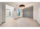 Bright dining room with tile floors, modern lighting, and neutral paint at 3467 N Hooper St, Buckeye, AZ 85396