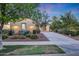 Landscaped front yard leading up to the warm and inviting home exterior at sunset at 3467 N Hooper St, Buckeye, AZ 85396