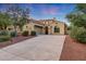 Charming home exterior features desert landscaping, mature trees, and a spacious driveway at dusk at 3467 N Hooper St, Buckeye, AZ 85396
