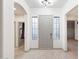 Bright foyer featuring tile flooring, a modern light fixture, and neutral paint at 3467 N Hooper St, Buckeye, AZ 85396