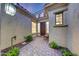 Charming front entrance with a cozy courtyard, patterned pavers, and exterior lighting at 3467 N Hooper St, Buckeye, AZ 85396