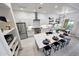 Bright open-concept kitchen featuring a central island, stainless steel appliances, and modern lighting at 3467 N Hooper St, Buckeye, AZ 85396