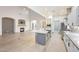 Open kitchen with gray cabinets, stainless steel appliances, and a large center island at 3467 N Hooper St, Buckeye, AZ 85396
