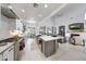 Open-concept kitchen with stainless steel appliances and an island leading to the living room at 3467 N Hooper St, Buckeye, AZ 85396