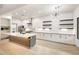 Modern kitchen with white cabinets, subway tile backsplash, large island, and stainless appliances at 3467 N Hooper St, Buckeye, AZ 85396