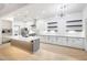 Modern kitchen with white cabinets, subway tile backsplash, large island, and stainless appliances at 3467 N Hooper St, Buckeye, AZ 85396