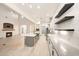 Open-concept kitchen features a large island, stainless steel appliances, and a fireplace in the living area at 3467 N Hooper St, Buckeye, AZ 85396