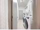 Well-lit laundry room features modern washer and dryer, storage cabinets, and access to the garage at 3467 N Hooper St, Buckeye, AZ 85396