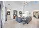 Spacious living room featuring a fireplace, vaulted ceilings, and plenty of natural light at 3467 N Hooper St, Buckeye, AZ 85396