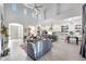 Spacious living room with a modern kitchen, fireplace and abundant natural light at 3467 N Hooper St, Buckeye, AZ 85396