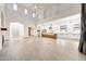 Open-concept living room with high ceilings, tile floors, and a modern kitchen at 3467 N Hooper St, Buckeye, AZ 85396
