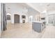 Open living space with vaulted ceilings, fireplace, and kitchen with a large center island at 3467 N Hooper St, Buckeye, AZ 85396