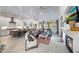 Open concept living space with modern fireplace, seating, and gourmet kitchen at 3467 N Hooper St, Buckeye, AZ 85396