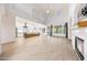 Bright living room with a fireplace, tile floors, and an open kitchen at 3467 N Hooper St, Buckeye, AZ 85396
