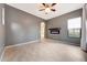 Bright living room with an electric fireplace, tile floors, neutral paint, and a large entry archway at 3467 N Hooper St, Buckeye, AZ 85396