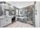 This main bathroom boasts marble accents, modern lighting, dual vanities, and a luxurious bathtub and shower at 3467 N Hooper St, Buckeye, AZ 85396