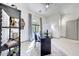 Bright home office featuring a large window, neutral color palette, ceiling fan, and stylish decor at 3467 N Hooper St, Buckeye, AZ 85396