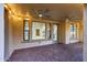 Covered patio featuring brick flooring, ceiling fans, and direct access to the home's interior through large windows and a door at 3467 N Hooper St, Buckeye, AZ 85396